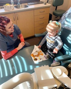 dental staff entertaining a young girl